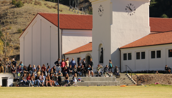 Long shot of onlookers afront the gym