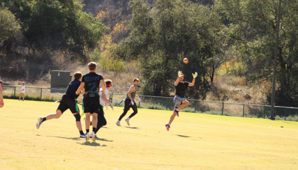 An upperclassman catches the ball in an open field