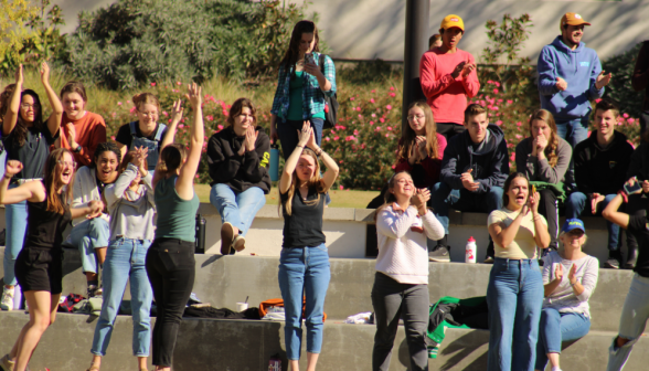 Onlookers clap and cheer