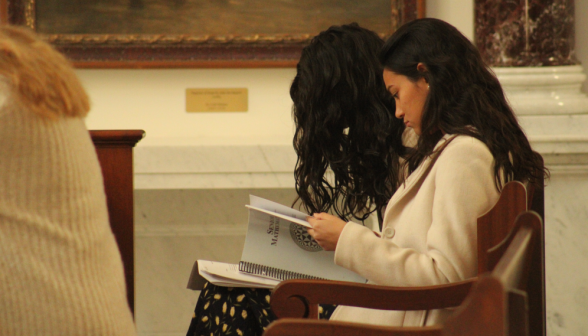 Two study in a pew in the Chapel
