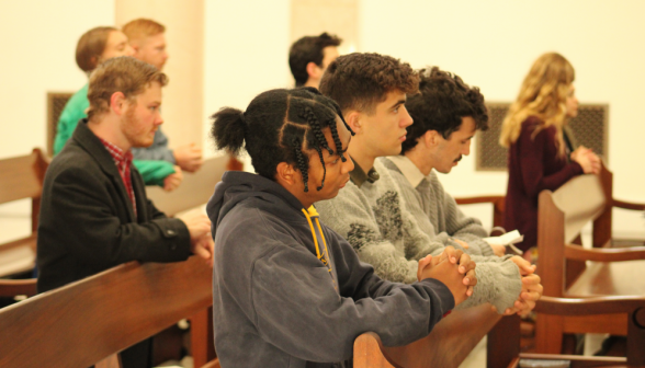 Another view of praying students in the Chapel