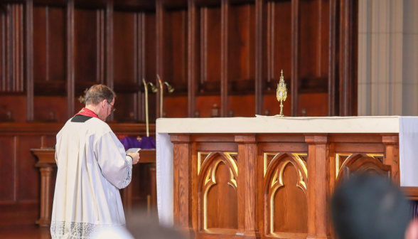 Fr. Markey reads a prayer before the relic