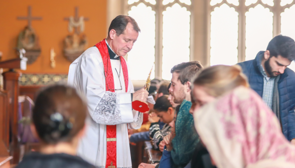 Fr. Markey presents the relic to a student