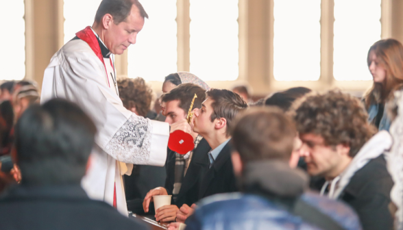 A student kisses the relic
