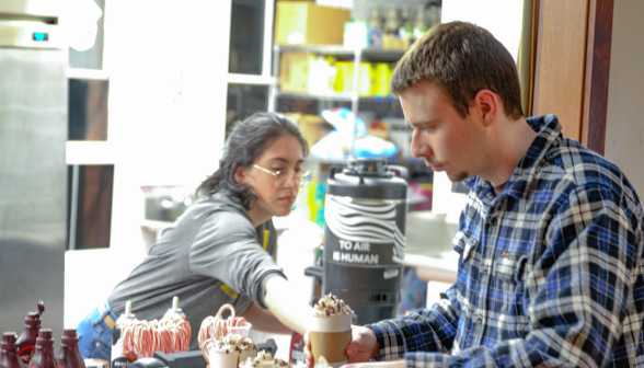 A coffee-shop worker serves a student