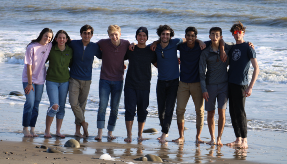 Nine pose at at the beach