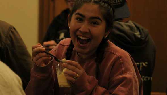 A smiling student enjoys her root beer float