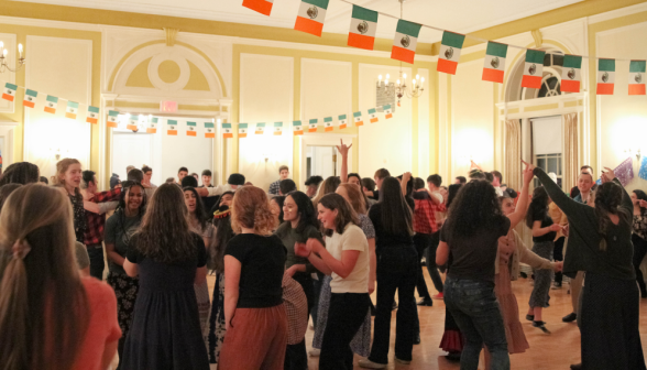 Students dance under strings of Mexican flags