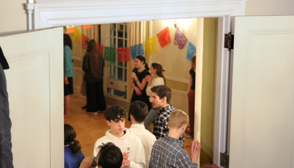 Students chatting at the doors to the dancefloor