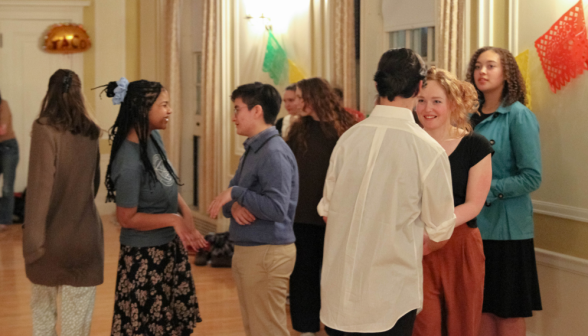 Students chatting at the edge of the dancefloor