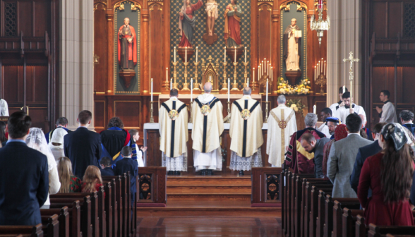 The four priests face the altar before the recessional