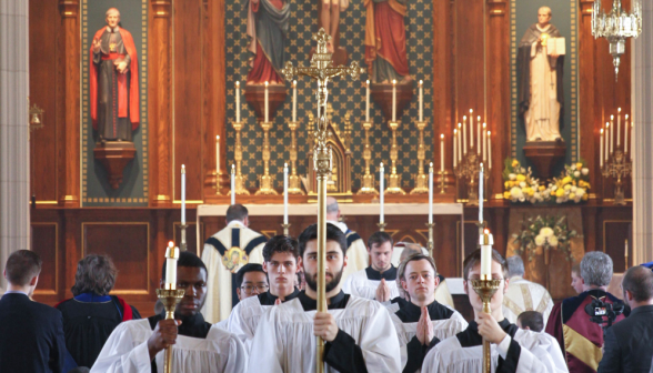 Altar servers recess behind the crucifer