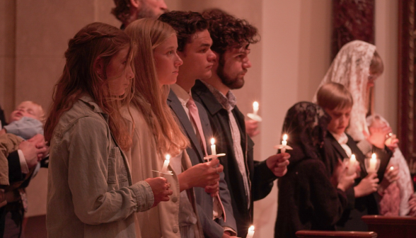 Four holding candles