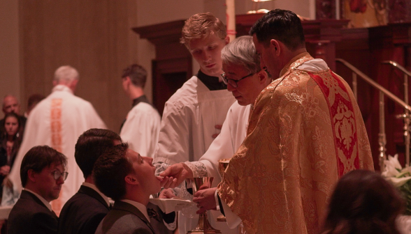 Students receive Communion at the rail