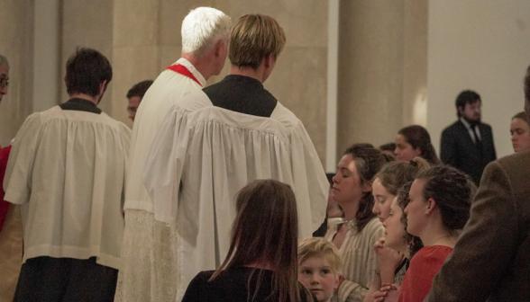 A priest administers Communion