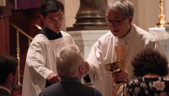 Fr. Chung gives Communion