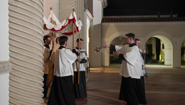 Servers incense the Eucharist