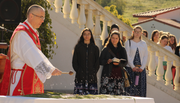 The priest blesses the palms