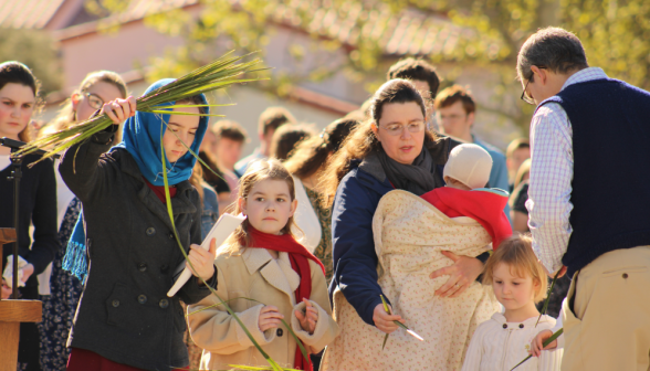 The congregation distributes palms to itself