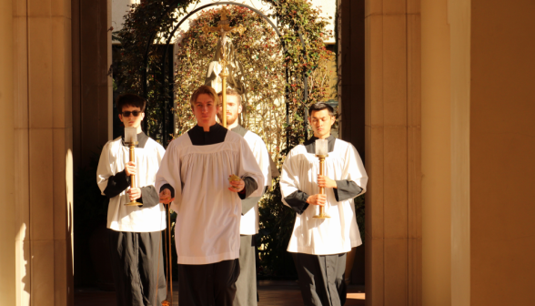 The altar servers round a corner