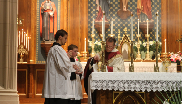 Fr. Markey prepares the water and wine