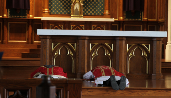 The priests prostrate themselves at the altar