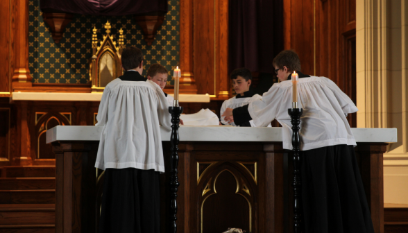 Servers lay the altar cloths