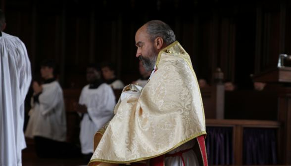 Fr. Viego holds the Sacrament with the veil