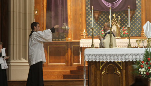 Thurifer incenses the priest