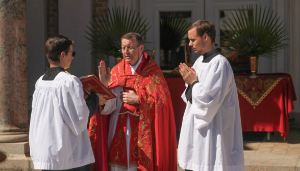 Fr. Markey reads afront the temporary altar