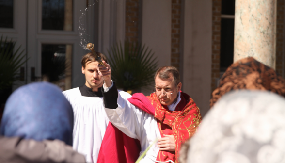 Fr. Markey asperges the palms