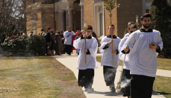 The altar servers process