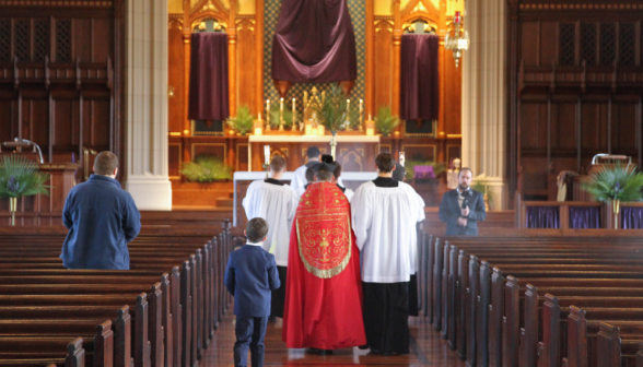 Fr. Markey processes up the altar
