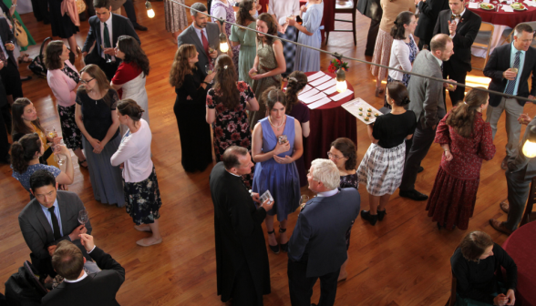 Guests congregate and chat before dinner starts