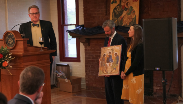 Dr. Cain presents Mr. and Mrs. Gardner with an icon of the Trinity