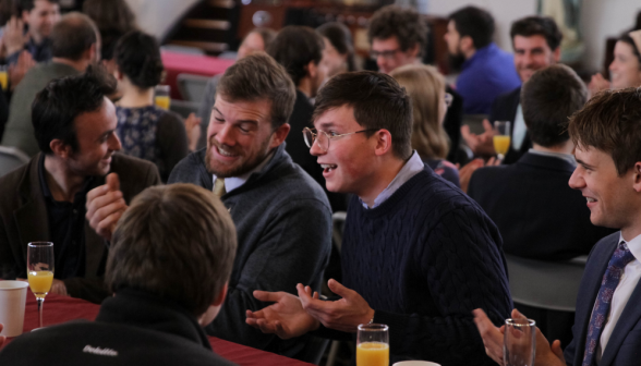 Students laugh and chat at the tables