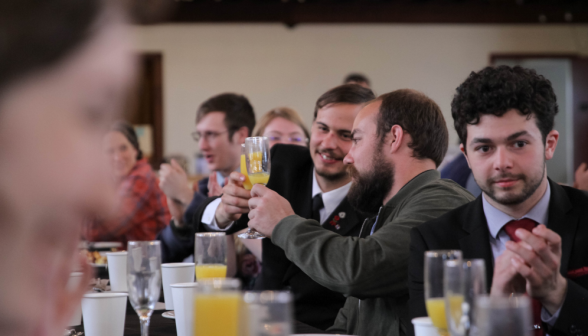 Students clink glasses and applaud