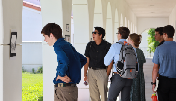 Students at art show on academic quadrangle