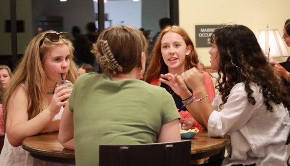 Four chat at a table