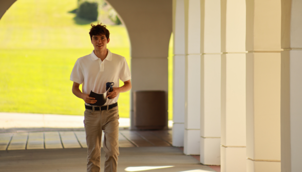 A student walks down the arcade