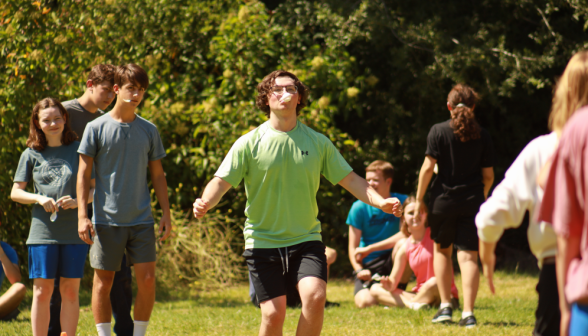 Another student carries an egg in the same fashion