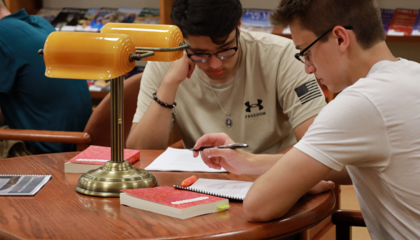 Two study at a table