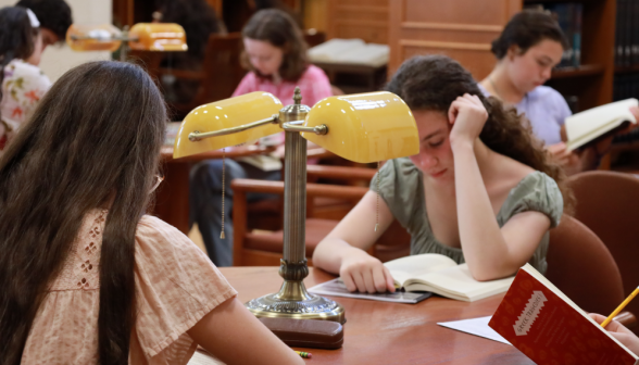 Three study at a table