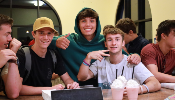 Three pose with their pink drinks