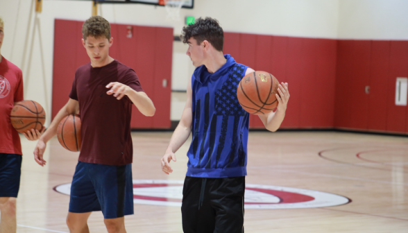 Two with basketballs in the gym