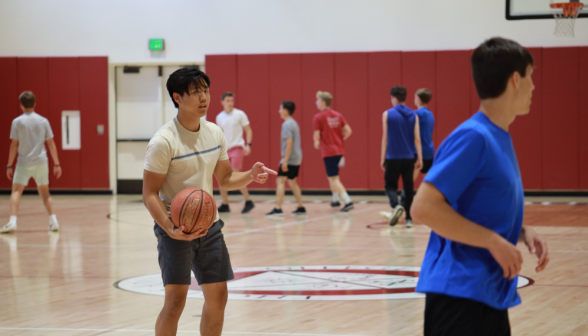 A student holds the basketball