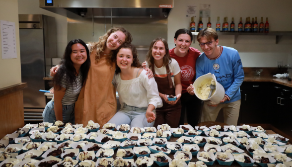 Six prefects pose in front of a table of sundaes