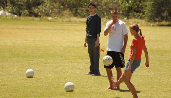 Three play soccer