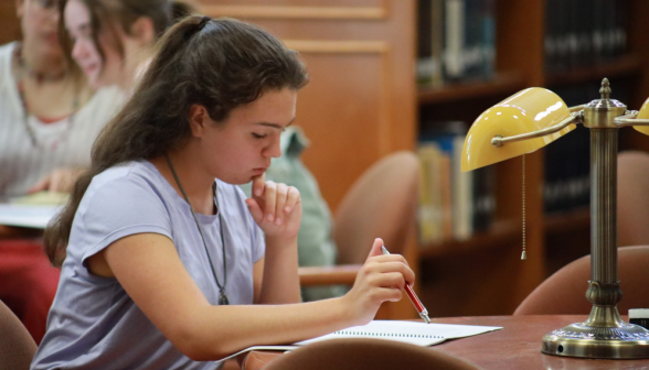 A student studies at a desk