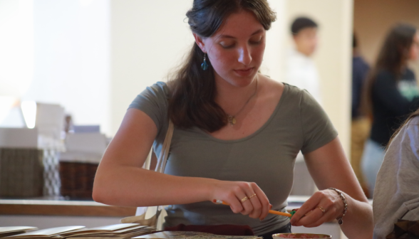 A student sharpens her pencil